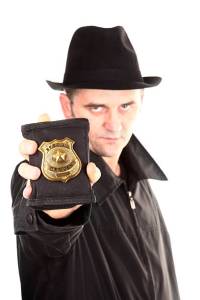 Here is an agent, holding golden special officer badge.